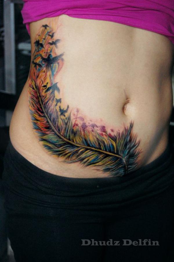 Birds flying our of feather side stomach tattoo