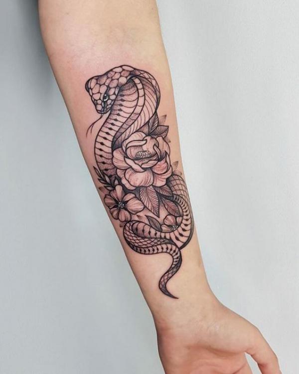 Black and cobra and rose forearm tattoo