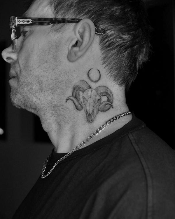 Black and grey Aries Ram and crescent moon neck tattoo