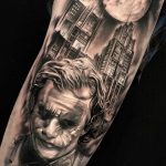 Black and grey Joker and city with moon tattoo