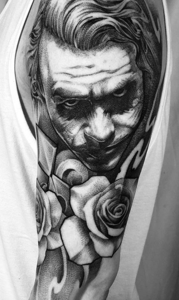 Black and grey Joker with rose tattoo sleeve
