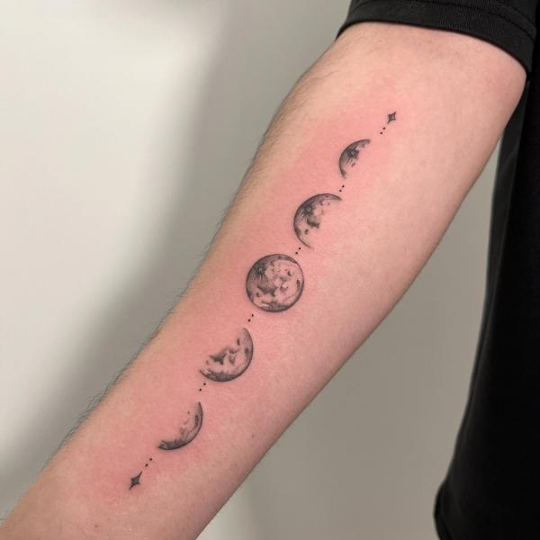 Black and grey Moon phases inner forearm tattoo