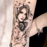 Black and grey Virgo woman with flowers tattoo