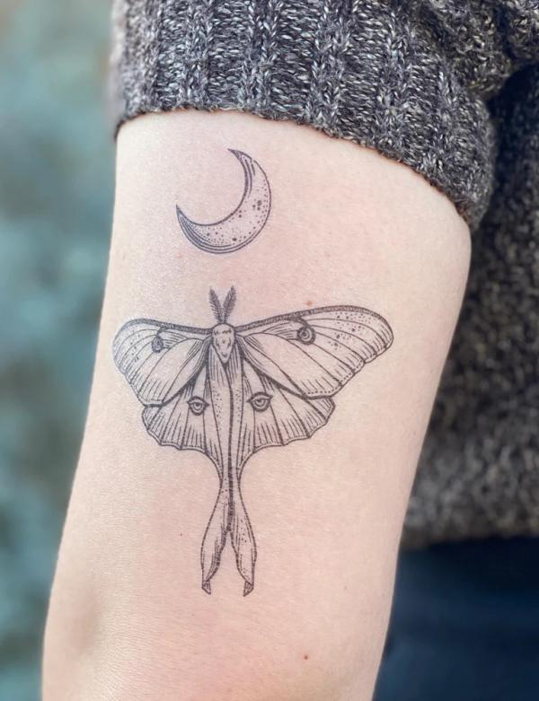 Black and grey luna moth and crescent moon back of arm tattoo