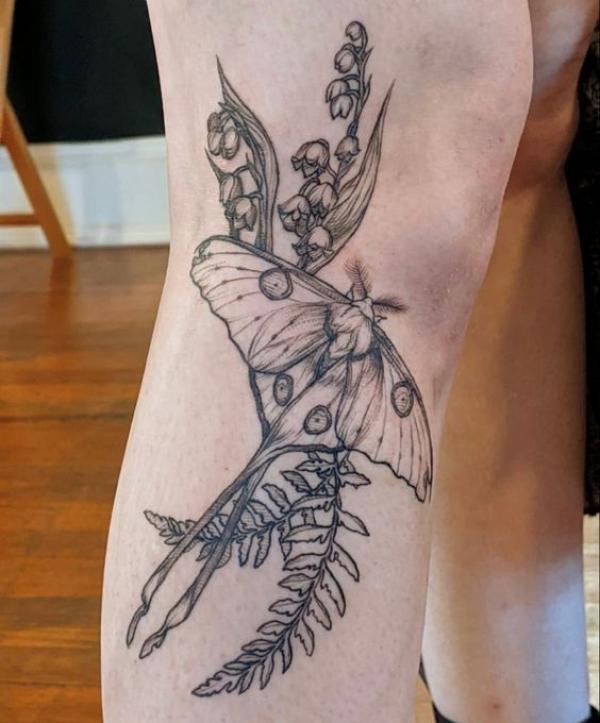 Black and grey luna moth and lily of the valley tattoo