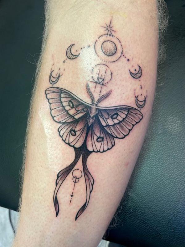 Black and grey luna moth and moon phases forearm tattoo