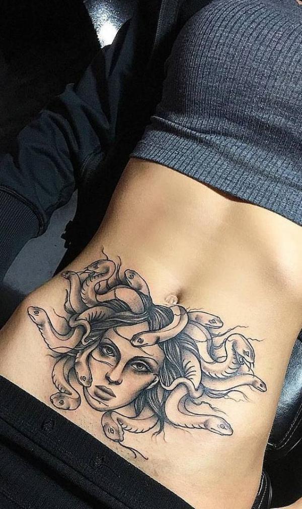 Black and grey medusa abdomen tattoo