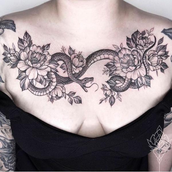 Black and grey rose and snake chest tattoo