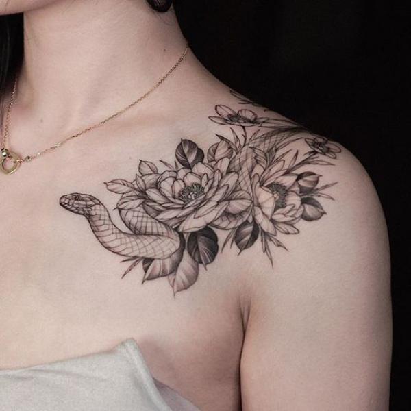 Black and grey rose and snake shoulder to chest tattoo