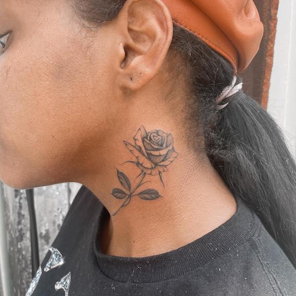 Black and grey small rose neck tattoo