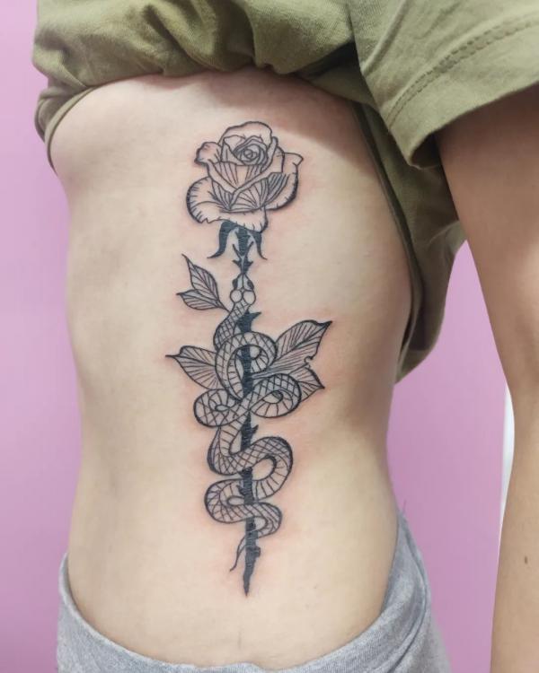 Black and grey snake and rose tattoo side tattoo