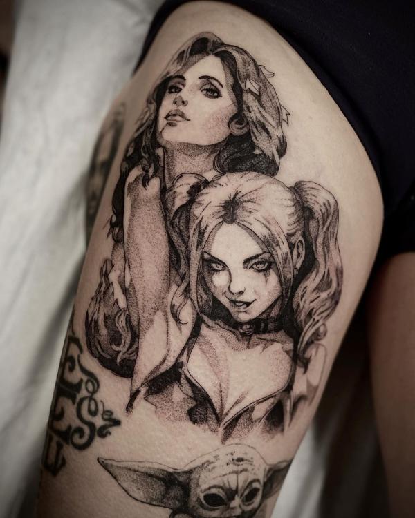 Black and white Harley Quinn and Poison Ivy tattoo on thigh