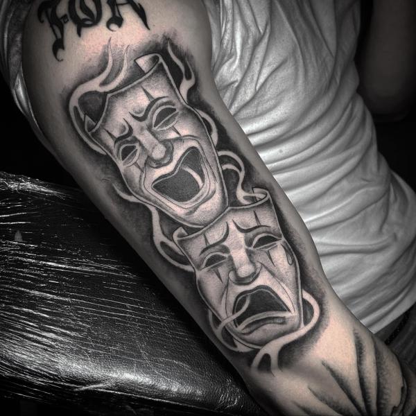 Black and white Laugh Now Cry Later half sleeve tattoo