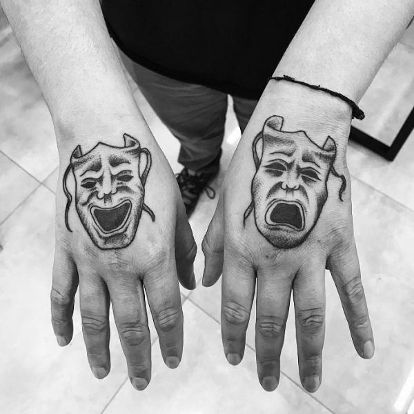 Black and white Laugh Now Cry Later hands tattoo