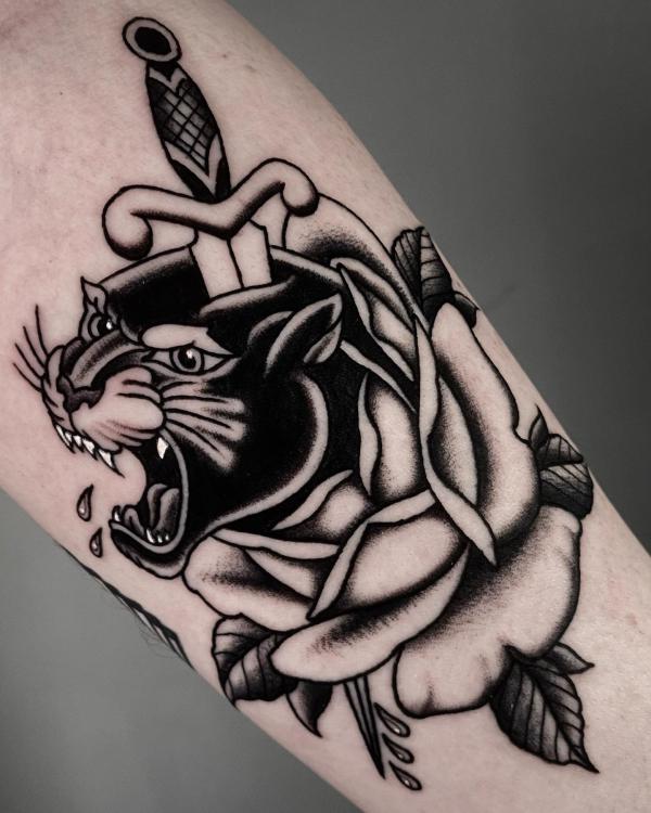 Black and white a dagger through a panther in rose tattoo