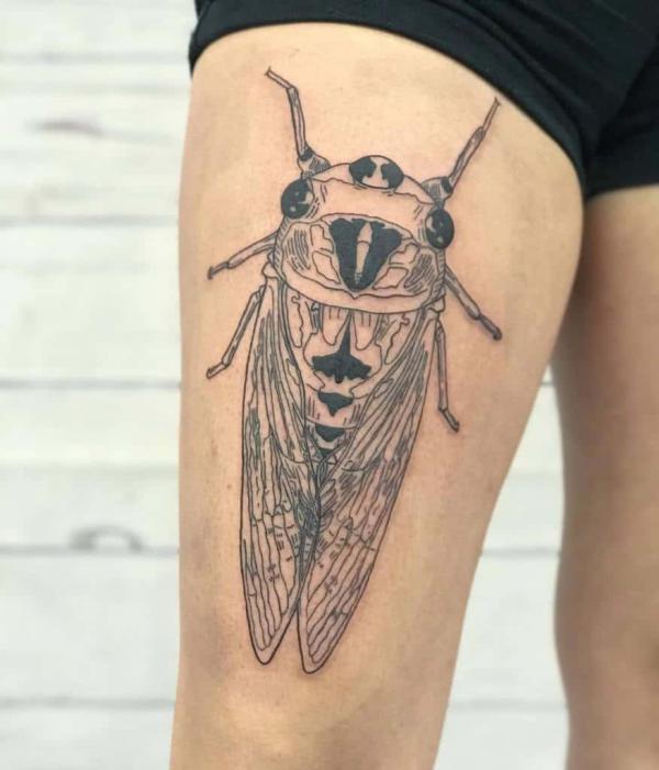 Black and white cicada thigh tattoo