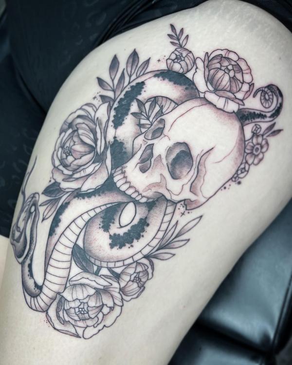 Black and white death eater with flowers thigh tattoo