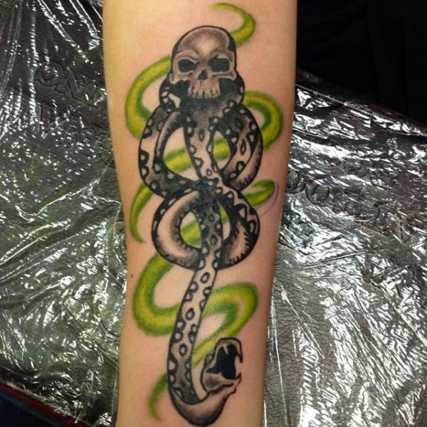 Black and white death eater with green swirls tattoo
