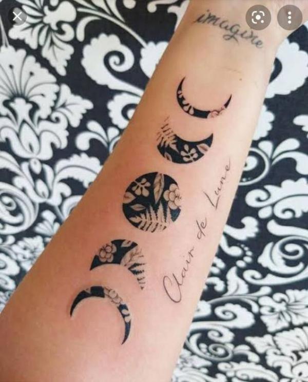 Black and white flower and fern Moon phases tattoo