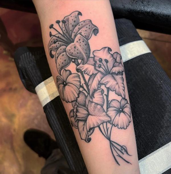 Black and white gladiolus and tiger lily tattoo