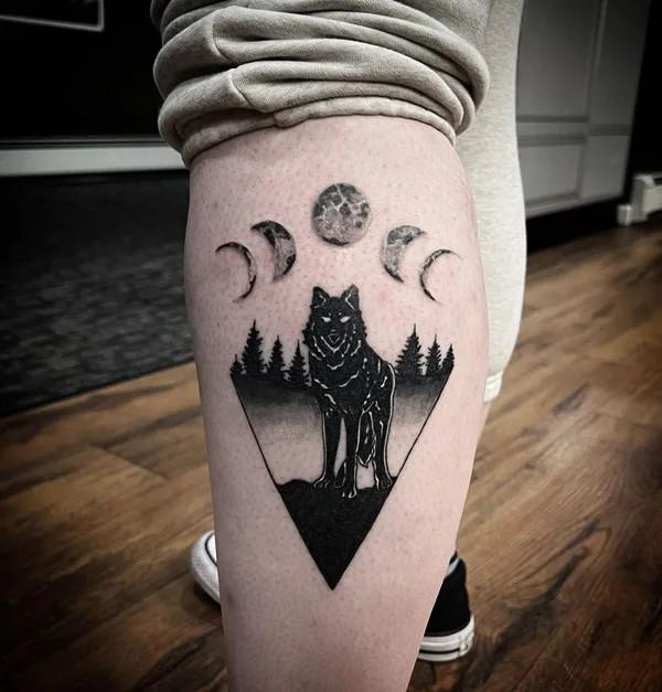 Black and white moon phases and wolf tattoo