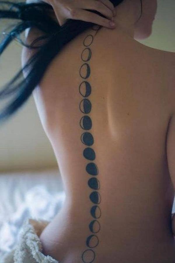 Black and white noon phases spine tattoo