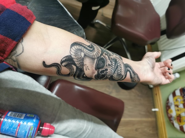 Black and white realistic death eater forearm tattoo