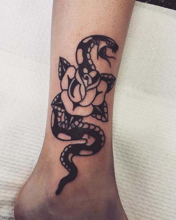 Black and white rose and snake ankle tattoo