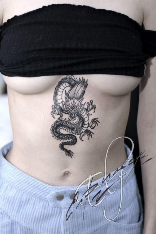 Black and white small dragon stomach tattoo