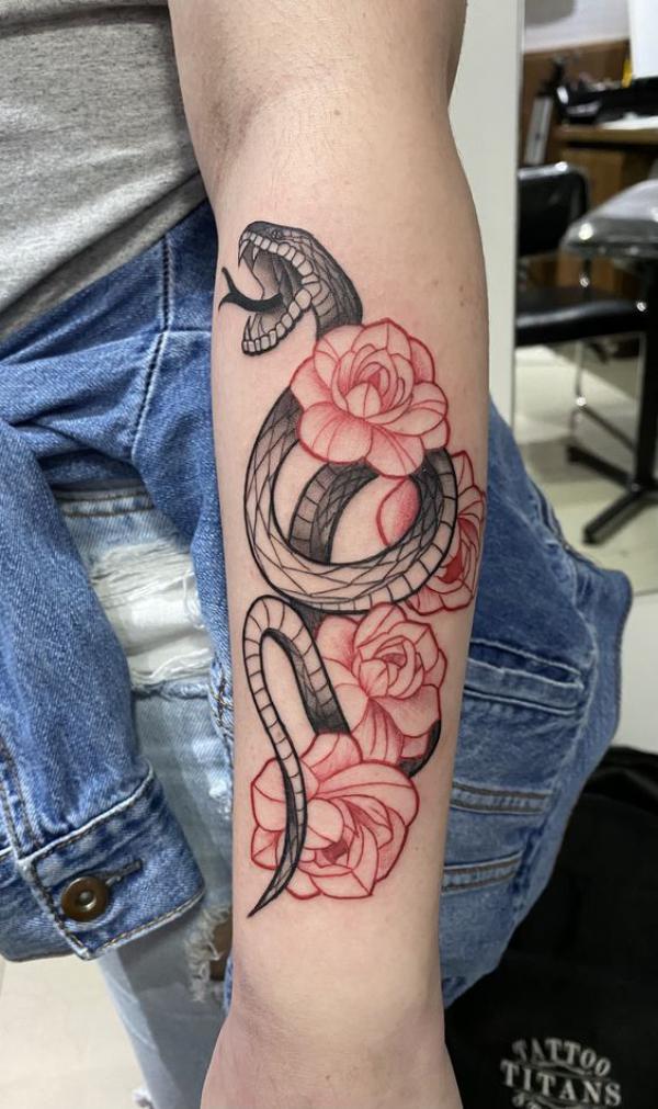 Black and white snake with rose tattoo forearm