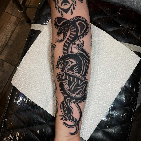 Black and white traditional panther and cobra tattoo