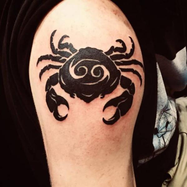 Black cancer with glyph shoulder tattoo