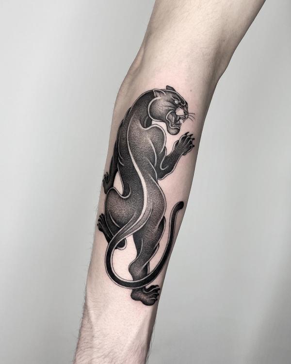 Black crawling panther forearm tattoo