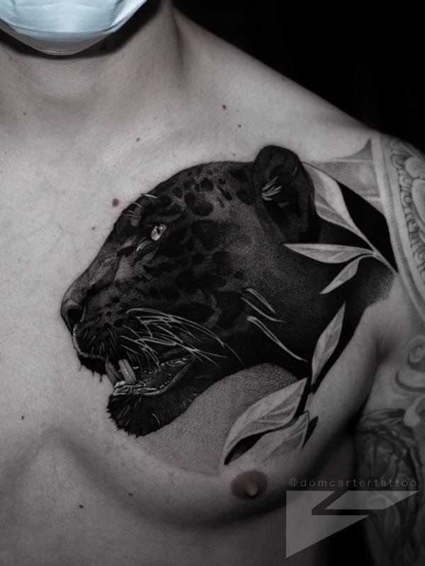 Black panther head chest tattoo realistic