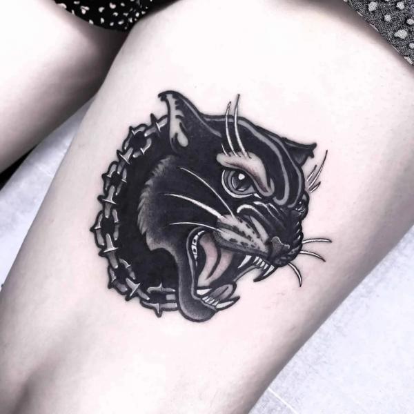 Black panther head with chain ring thigh tattoo