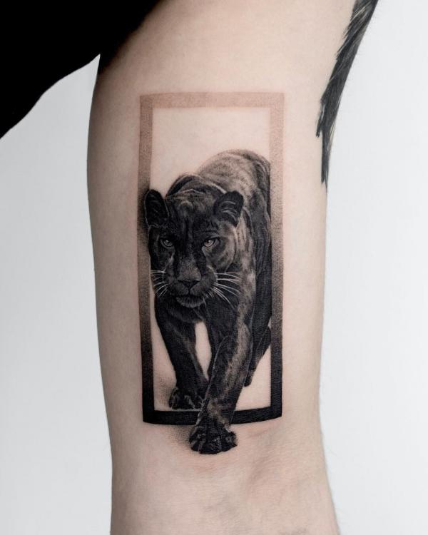 Black realistic panther bicep tattoo