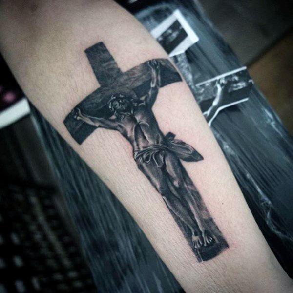 Blackwork cross tattoo forearm with jesus
