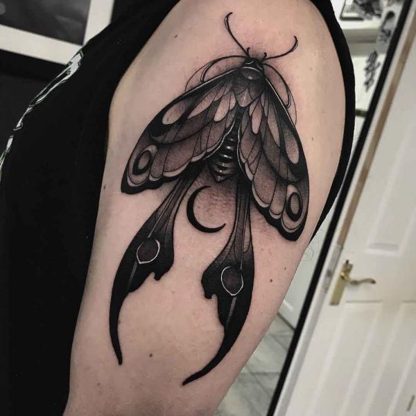 Blackwork luna moth tattoo on upper arm