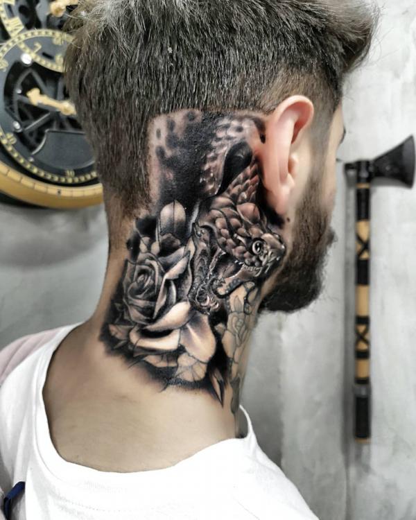 Bold black and white snake and rose neck tattoo for men