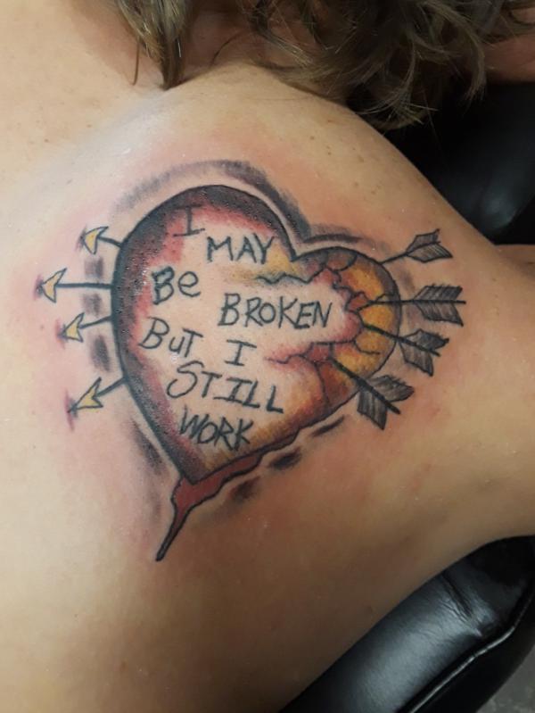 Broken heart with arrows and words I may be broken But I still work