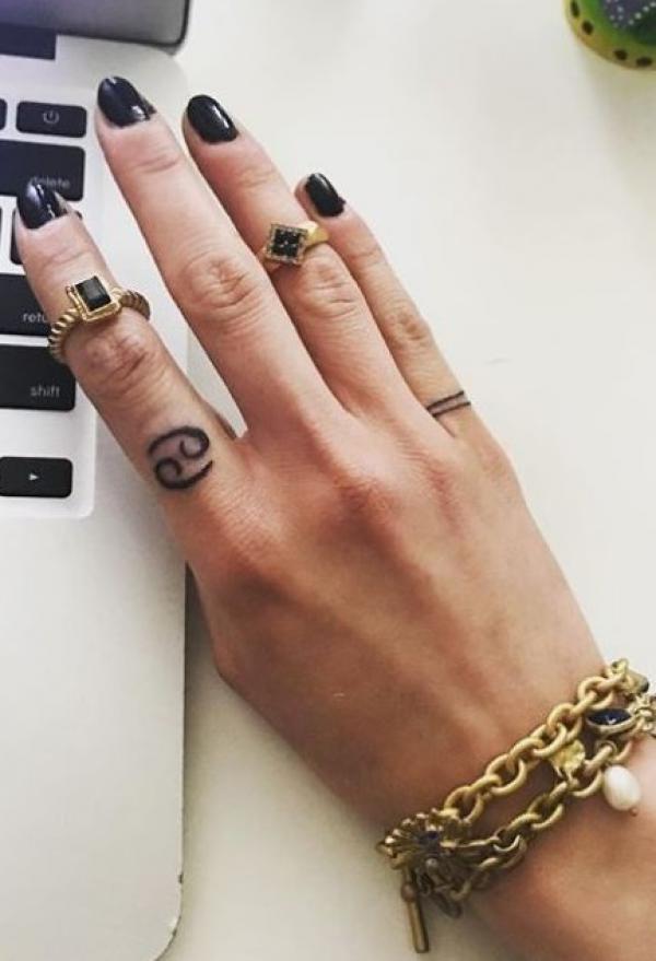 Cancer glyph finger tattoo
