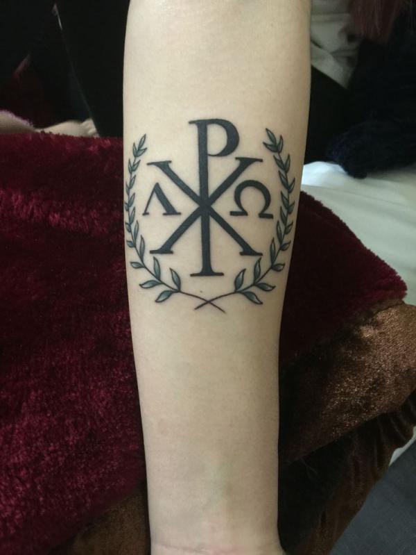 Chi Rho with Laurel wreath tattoo on forearm