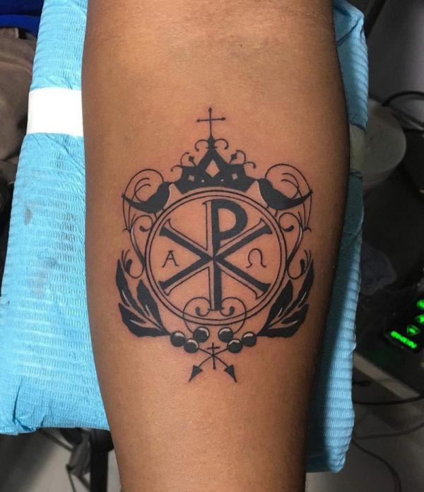 Chi Rho with crown tattoo on forearm