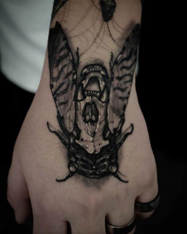 Cicada hand tattoo blackwork