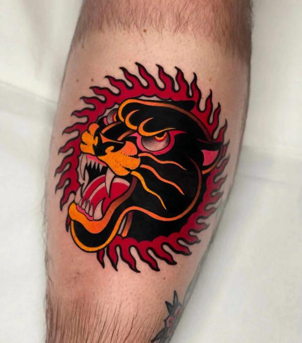 Circular flaming panther head tattoo