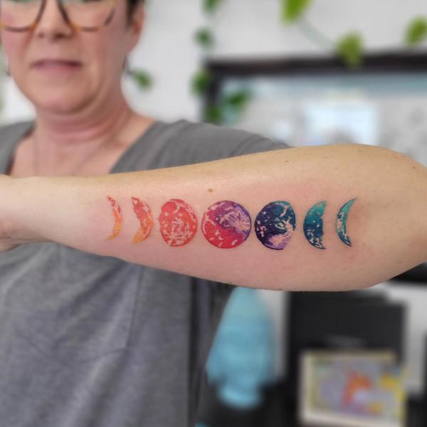 Colored Moon phases outer forearm tattoo