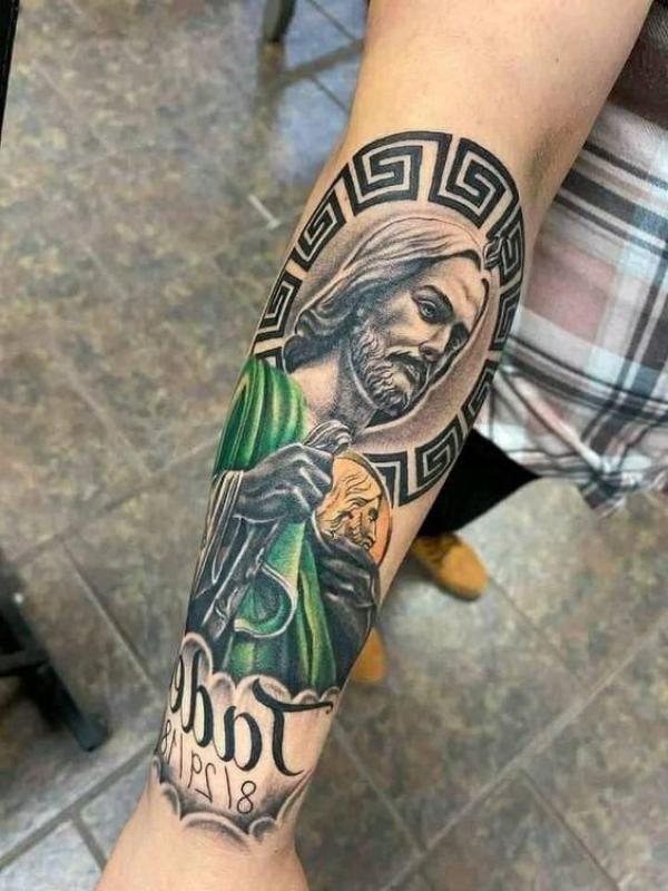 Colored San Judas portrait with Greek Key outer forearm tattoo