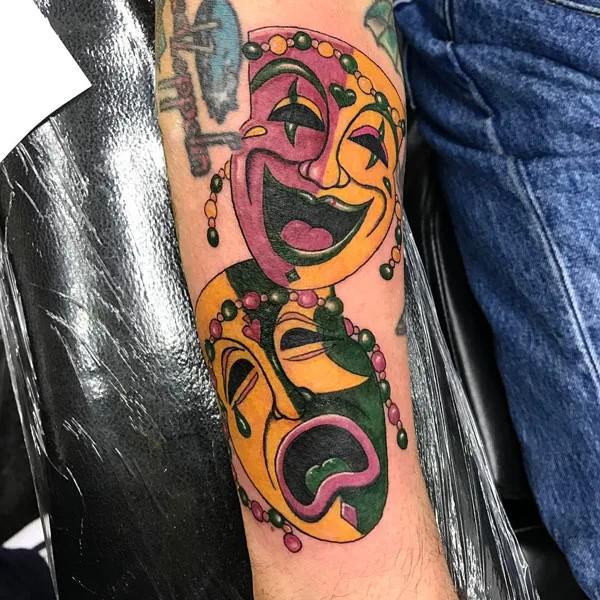 Colored laugh now cry later arm tattoo