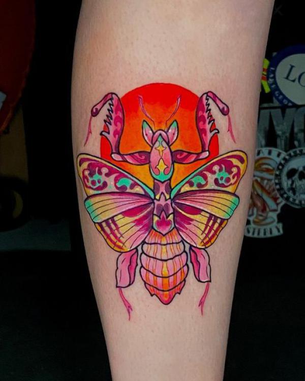 Colorful praying mantis and sun tattoo
