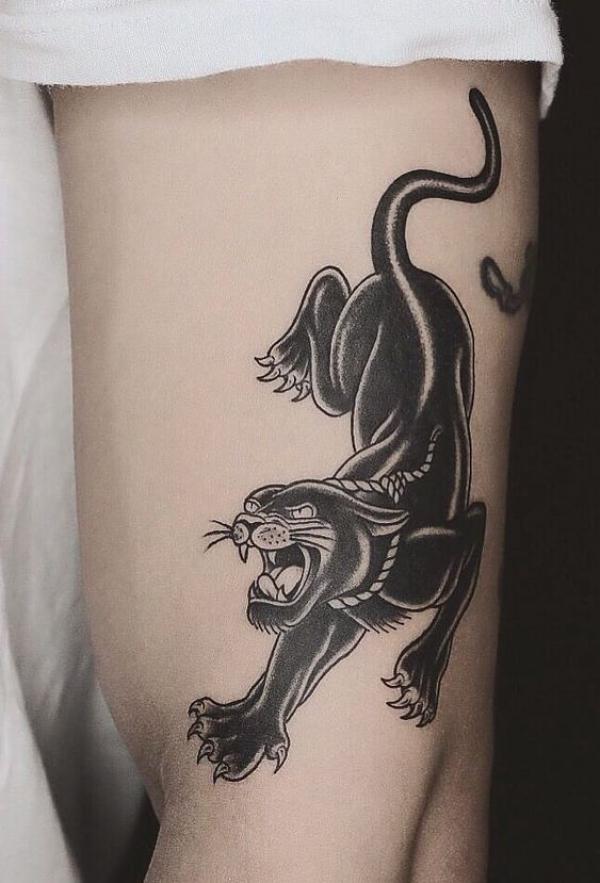 Crawling panther upper arm tattoo